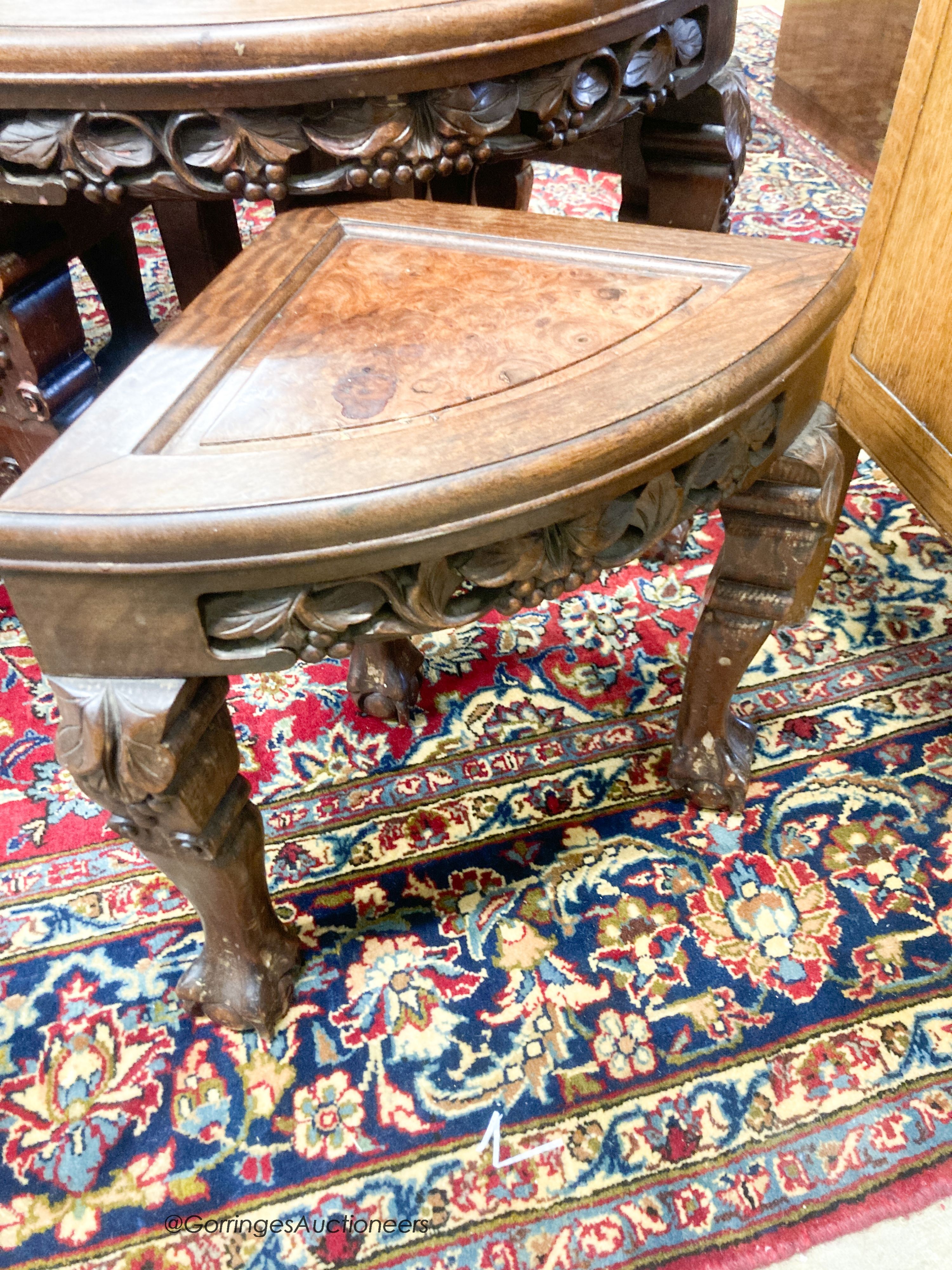 A Chinese circular carved hardwood circular low table with a burr wood centre panel and companion nest of four tables with claw feet, diameter 70cm, height 51cm